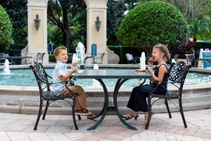 two children sitting at a table eating ice cream at Omni Orlando Resort at Championsgate in Kissimmee