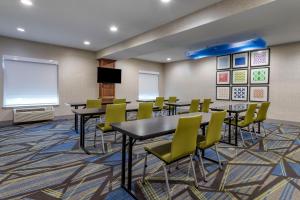 a conference room with tables and chairs and a whiteboard at Holiday Inn Express Hotel and Suites Natchitoches, an IHG Hotel in Shamard Heights