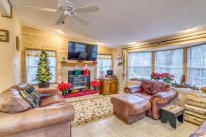 a living room with leather furniture and a fireplace at Cozy Lakefront Cottage Getaway Branson MO. in Branson