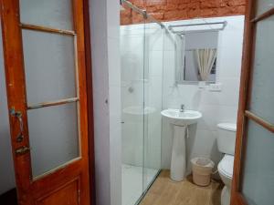 a bathroom with a shower and a sink and a toilet at CASA DE LOURDES - LA CANDELARIA in Bogotá +58 photos