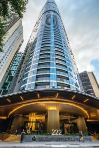 a tall building with people standing in front of it at CBD Cozy 2Beds Apt at Brisbane Tallest building With Free Parking in Brisbane