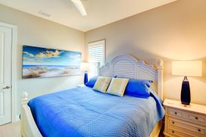a bedroom with a bed with a blue comforter at Luxury Home in Downtown Sarasota, HTD POOL/Hot tub in Sarasota +21 photos