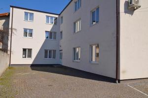 two white buildings sitting next to each other at Apartament 9 Central in Târgu-Mureş