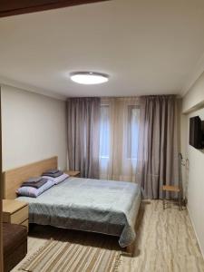 a bedroom with a large bed in a room at Апартамен в Манастира 3 in Smolyan