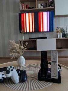 a living room with two video game controllers on a table at Bis zu 6 Personen, Bahnhofs- & Zentrumsnah, Südheide, Netflix und PS4 in Celle