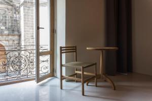 a chair and a table in front of a window at Círculo Mexicano, a Member of Design Hotels in Mexico City