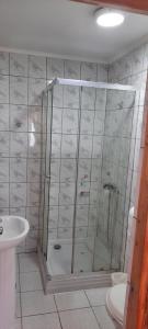 a bathroom with a shower and a sink at Hostal Ribera de Quitor in San Pedro de Atacama