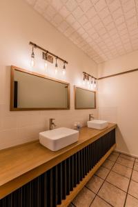 a bathroom with two sinks and a large mirror at The Raging Elk Adventure Lodging in Fernie
