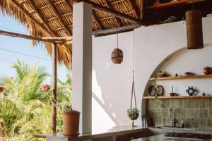 an open kitchen with a view of the palm trees at Casa Zala in El Paredón Buena Vista