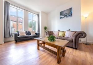 a living room with a couch and a coffee table at Spacious Cricklewood Apartment sleeps 4 in London
