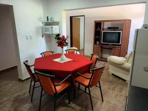 uma sala de jantar com uma mesa vermelha e cadeiras em Casa Los Duraznos em San Rafael