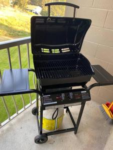 a grill sitting on a cart on a porch at Lovely 2 bedroom condo, 2 minute walk fr downtown in Invermere