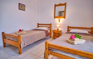 A bed or beds in a room at Maro Apartments Arillas Corfu