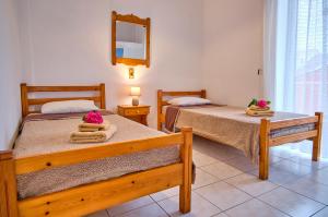 A bed or beds in a room at Maro Apartments Arillas Corfu
