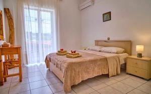 A bed or beds in a room at Maro Apartments Arillas Corfu