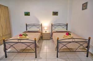 A bed or beds in a room at Maro Apartments Arillas Corfu