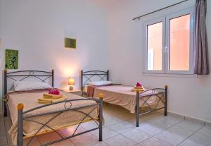A bed or beds in a room at Maro Apartments Arillas Corfu
