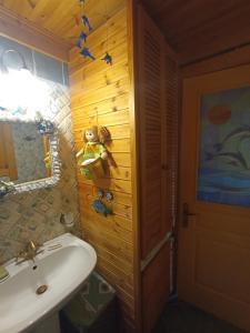 a bathroom with a sink and a wooden wall at Rados chalet in Rádhos +23 photos