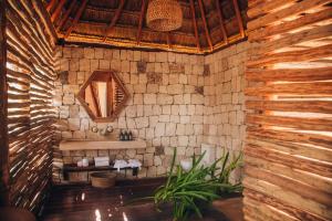 a bathroom with a sink in a brick wall at Ikal Tulum Hotel in Tulum