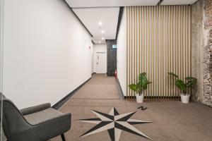 a hallway with a chair and stars on the floor at Bakan - Sainte Catherine in Montréal