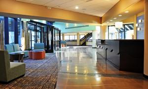 a large lobby with a waiting area in a building at Holiday Inn Express Princeton Southeast, an IHG Hotel in Plainsboro