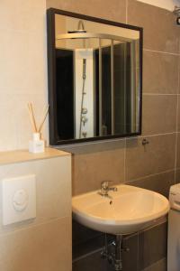 La salle de bains est pourvue d'un lavabo et d'un miroir. dans l'établissement 3 Zimmer Apartment am Leopoldplatz, à Berlin