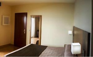 a bedroom with a bed and a door to a hallway at Rincón Sol in Rincón de la Victoria