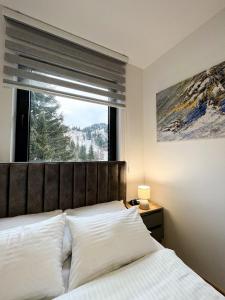 Ένα ή περισσότερα κρεβάτια σε δωμάτιο στο Apartmani Obućina Kapije Jahorina