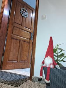 a santa claus is sitting in a basket in front of a door at La Casita del Arco Panorámico in San Pedro