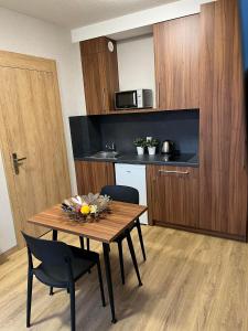 a kitchen with a table and chairs in a room at Apartamenty Polna 60 in Żory