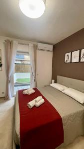a bedroom with a bed with two towels on it at AMERICAN GARDEN HOUSE in Nettuno +194 photos