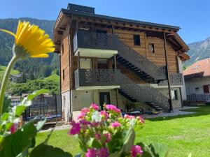 ein Gebäude mit Treppen und Blumen davor in der Unterkunft Villa Dolomiti in St. Ulrich in Gröden
