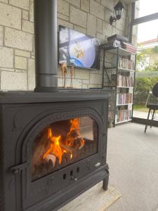 a fireplace in a living room with a fire at Dalyan Risus Suite in Çeşme