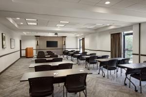 a conference room with tables and chairs and a screen at Hyatt Place Princeton in Princeton