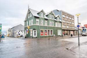 a green building on the side of a street at The Gallery in Reykjavík
