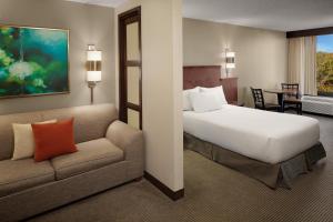 a hotel room with a bed and a couch at Hyatt Place Princeton in Princeton