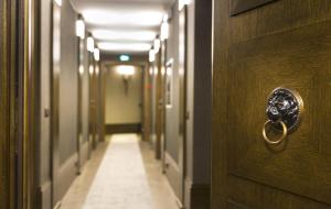 a hallway with a door with a face on it at Hotel Balestri - WTB Hotels in Florence