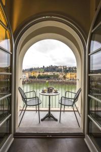 a balcony with two chairs and a table at Hotel Balestri - WTB Hotels in Florence