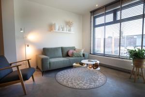 a living room with a couch and a table at Vakantiewoningen Liefst in Epen in Epen +45 photos