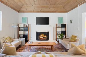 a living room with a couch and a fireplace at Hacienda Salida in Palm Springs