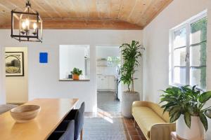 a living room with a table and a couch at Hacienda Salida in Palm Springs