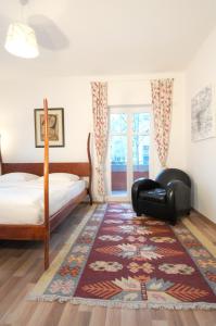 a bedroom with a bed and a chair and a rug at Apartement in Stadtvilla in Berlin