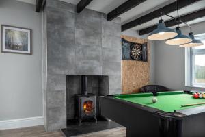 a room with a pool table and a fireplace at Pen-y-Coed ⥈ Modern ⥈ Hot Tub ⥈ Beautiful Views in Abergele