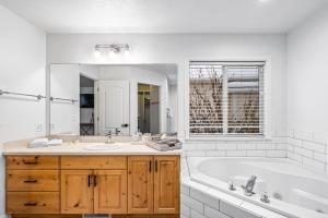 a white bathroom with a tub and a sink at Quiet Comfortable Cliffside Estate near USU in Logan