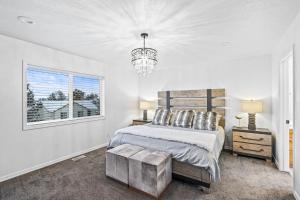 a bedroom with a bed and a window and a chandelier at Quiet Comfortable Cliffside Estate near USU in Logan