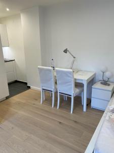 a room with a table and two chairs and a desk at Lovely Apartment close to the Heart of Nürnberg in Nürnberg