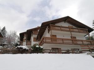 a house with snow in front of it at Appartamento Bellavista in Cavalese