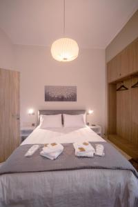 a bedroom with a bed with two towels on it at Rodon Premium in Kalavrita
