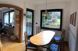 a dining room with a wooden table and chairs at Haus Nacke in Möhnesee