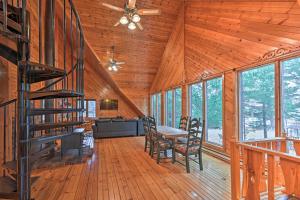a living room with a table and chairs in a cabin at Waterfront Arkdale Retreat 2 Acres with Deck and View in Arkdale